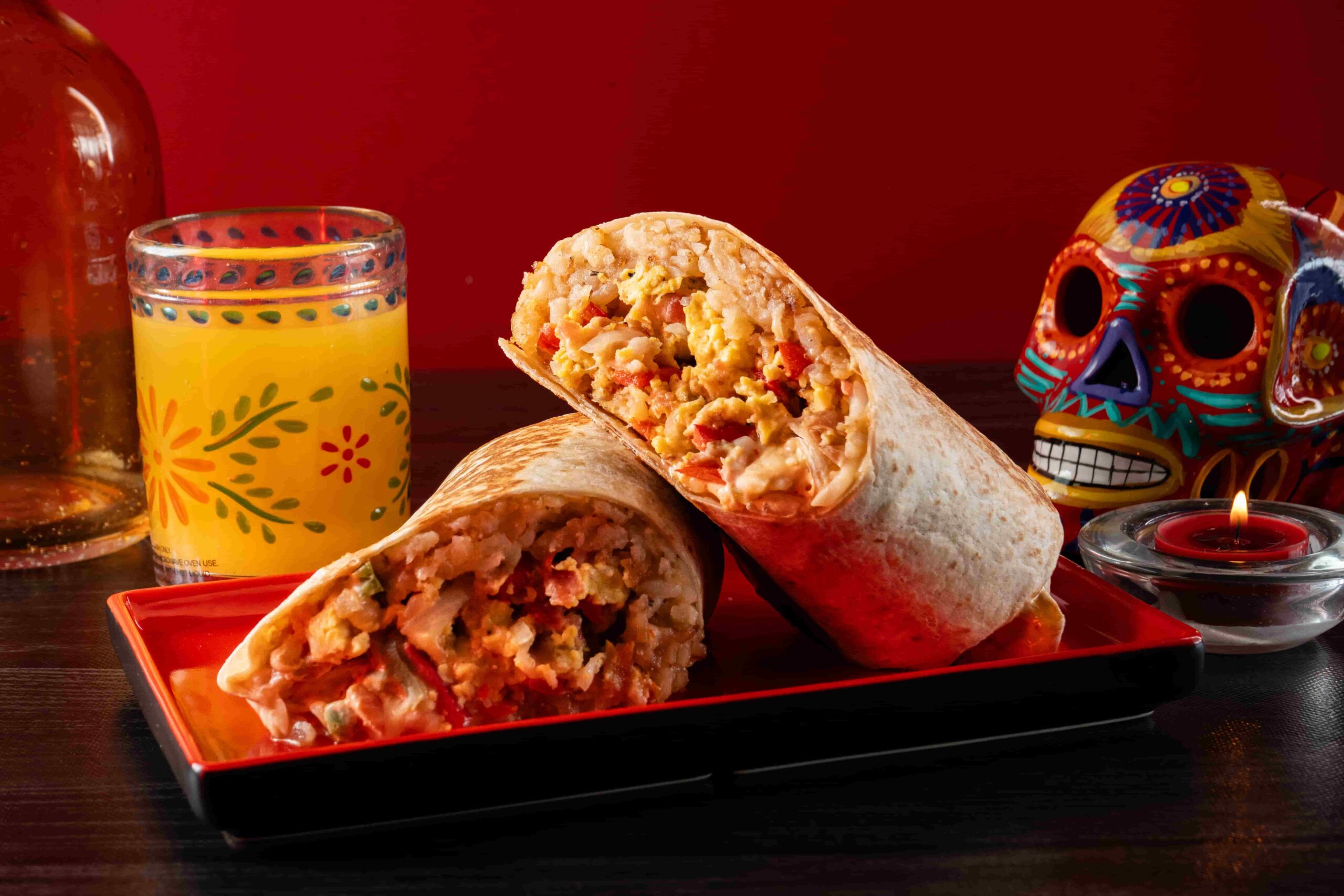 Birria burrito with rice beans cheese and consommé
